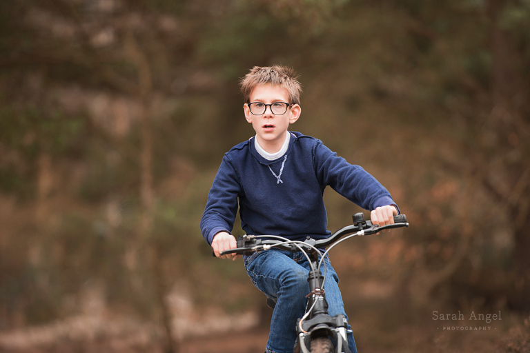 Charlie and Rosie, playing chase on heir bikes with Surrey Family Photographer